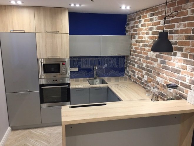 Grey-blue modern kitchen with accent brick wall