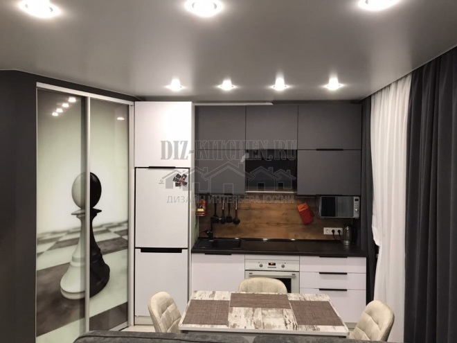 Minimalistic white and gray kitchen in a bachelor studio